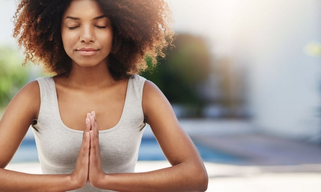 a woman in a tank top doing yoga