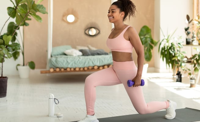 a woman in pink sports bras and a pink bra top exercising