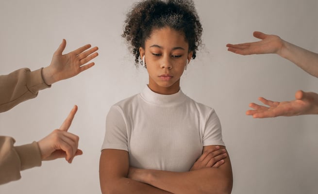 a woman with her hands on her chest and hands in the air