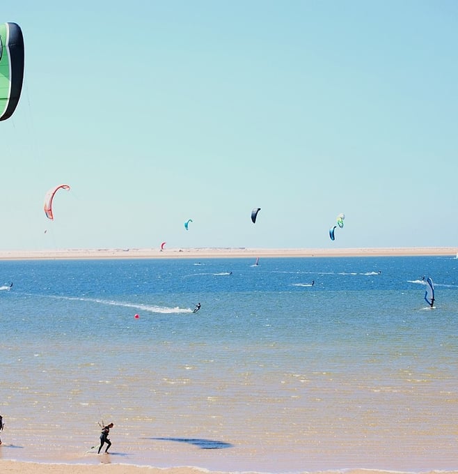 morocco essaouira a couple of people are parasailing in the ocean
