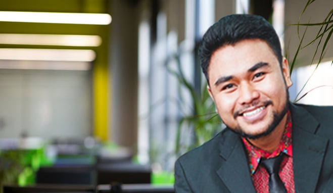 a man in a suit and tie smiling