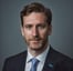 a man in a suit and tie with a blue tie