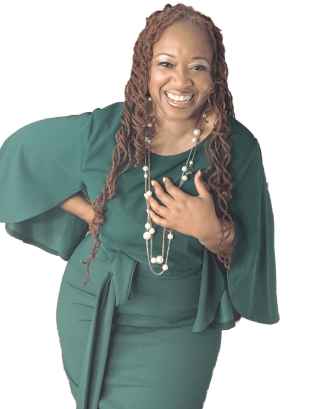 Shenell is pictured laughing with one hand at her waist and the other clutching her pearls