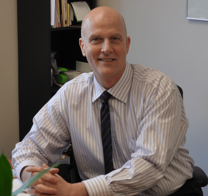 David Lindsay Moir sitting at desk