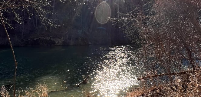 a river being Sunkissed by rays of the sun.