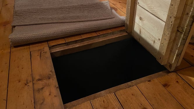 a door way with a door open and a rug rug on the floor