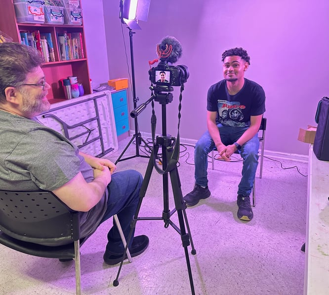 a man sitting in a chair in a room