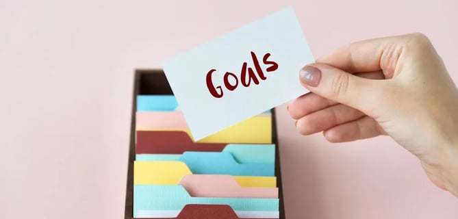 a person holding a note card with a notepad on it