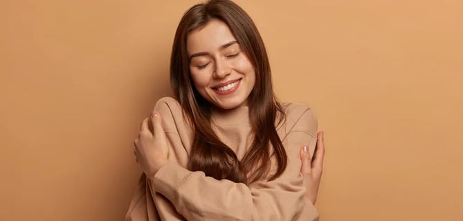 a woman with her arms crossed and smiling