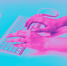 a person's hands typing on a keyboard
