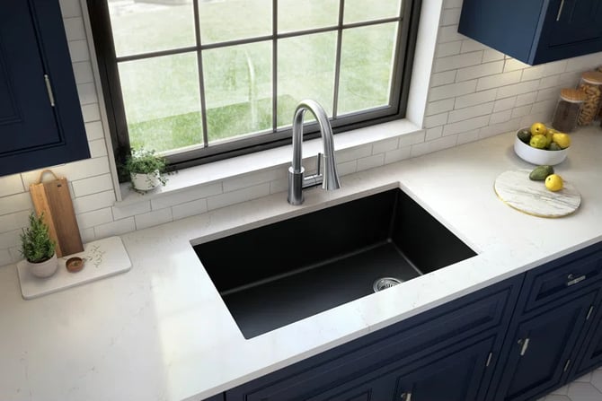 a kitchen sink with a sink and a bowl of fruit