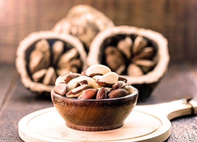nuts nuts and nuts in a bowl on a wooden table