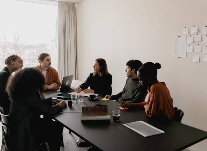 a group of people sitting around a table