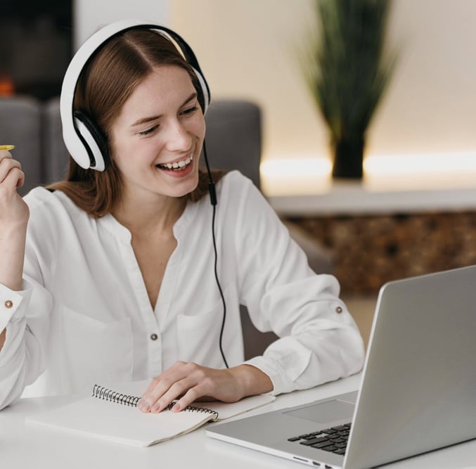 a woman with headphones and headphones on a laptop
