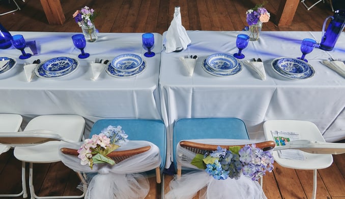 a table with a plate set and flower for a wedding