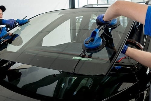 a man cleaning a car with a vacuum
