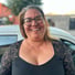 a woman with glasses and a black top apoderada en escuela de karate