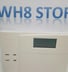 a white and blue alarm clock with the words wh8 store on it sistem alarm keamanan 