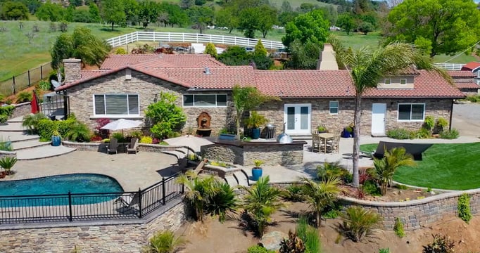 a house with a pool and a fenced in area