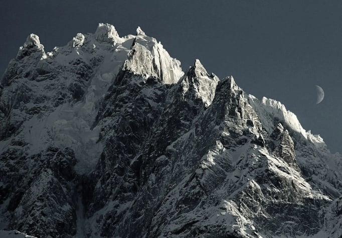 a mountain with a moon in the sky symbolizing leaders and potential to reach