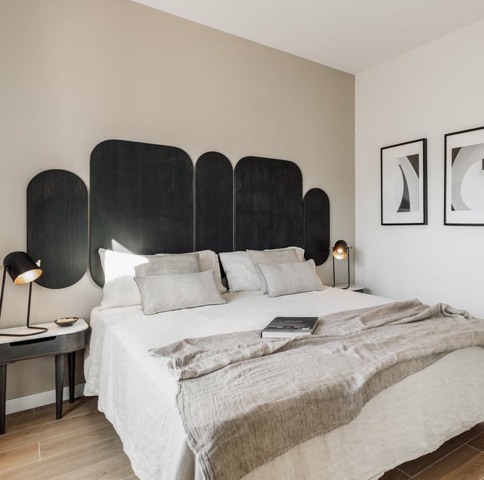Vibrant bold black wood headboard design in a bedroom with neutral colours and natural materials