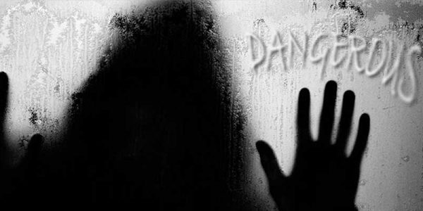 a person's hands are touching the wall of a window