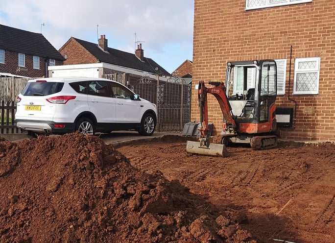 Mini digger in use for drainage work in Oldbury