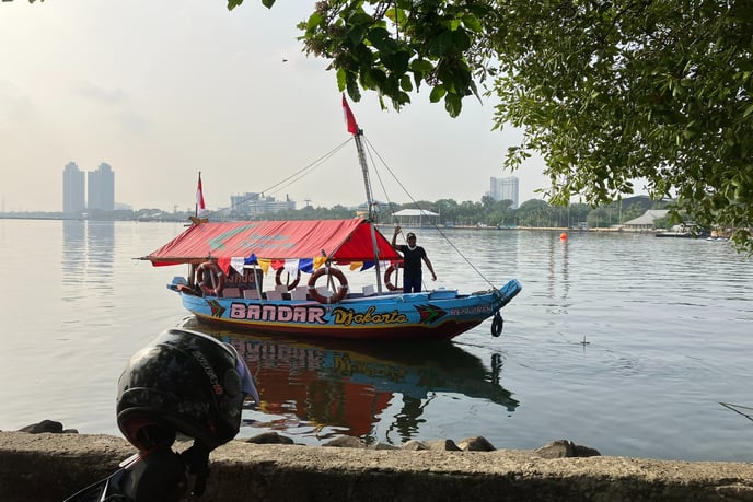 man on boat Ancol beach Jakarta