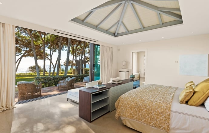 Master suite at Villa El Rincon in Marbella, offering unobstructed views of the gardens and the sea.