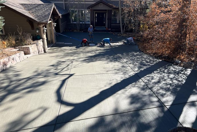 concrete contractors working on a concrete driveway in lakewood, co