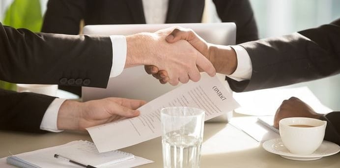 a business meeting with a handshake of two people