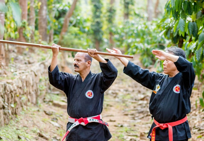 Hanshi tetsuo Taka Miyagi teaching Hanshi Ravindran K.P a kobudo technique.