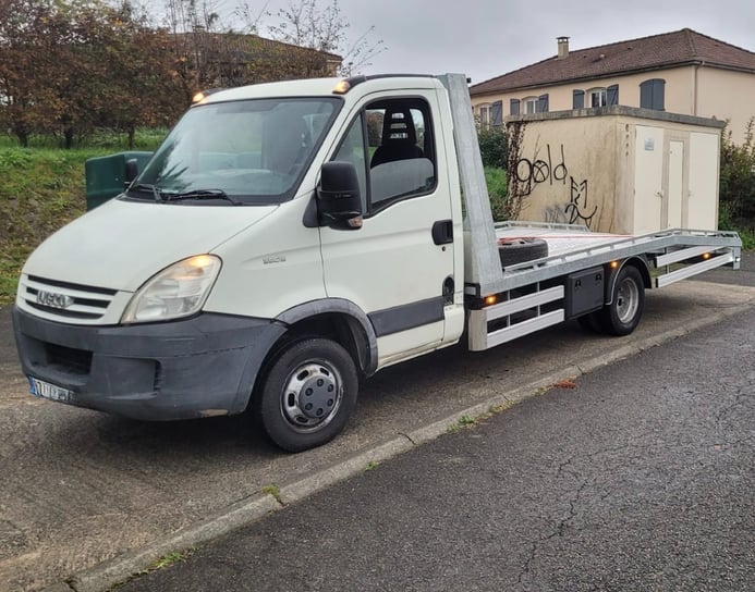 a truck with graffiti on it's side of the road