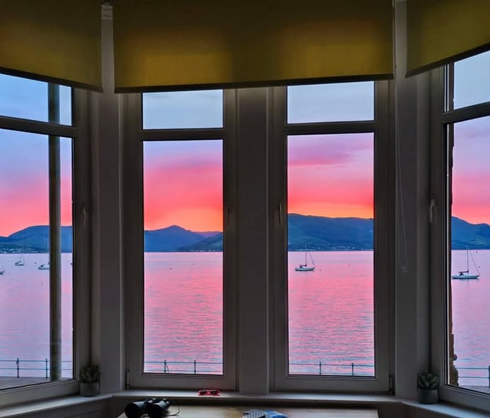 View from the window at at Gourock Seaview Holiday Let with a view of the ocean and sunset
