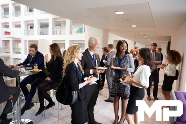 a group of people standing around a table