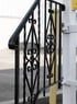 a black and white railing railing with a yellow sign