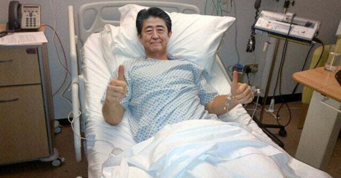 Shinzo Abe with thumbs up in hospital bed