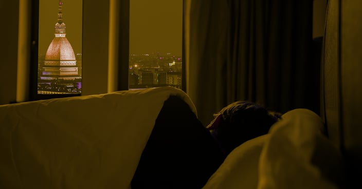 A person sleeping peacefully in cozy bedroom night sky– deep sleep self-care and wellness healing.