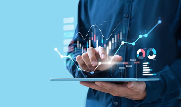 Man holding tablet money, stocks, graph