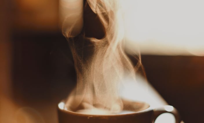 A steaming cup of coffee on a cozy table – symbolizing the start of a focused, energized morning.