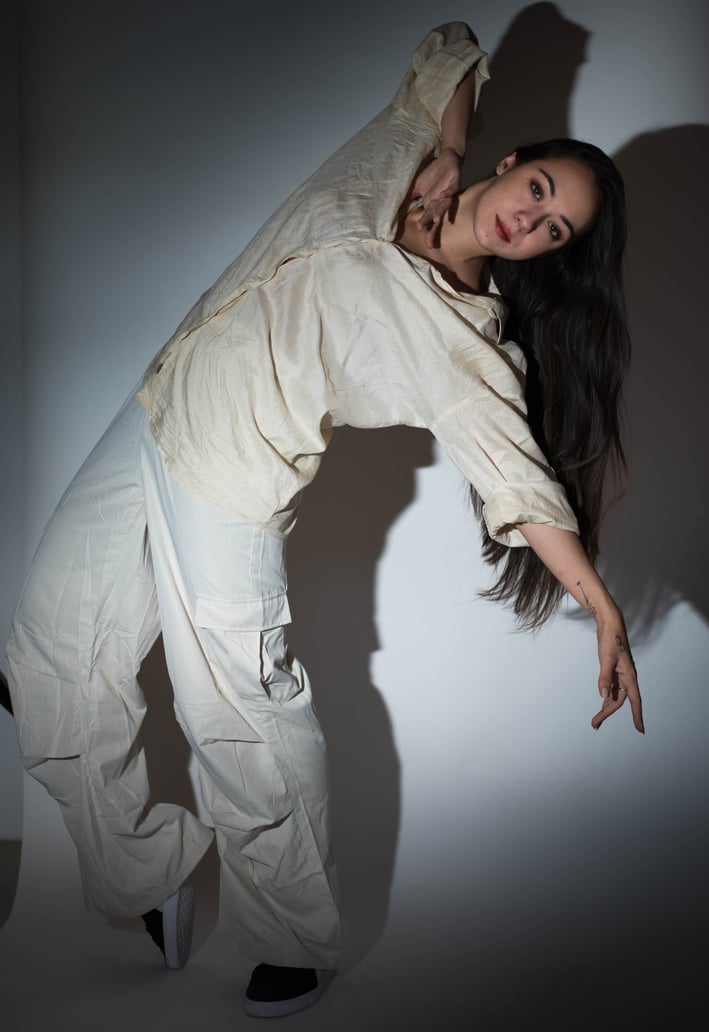 a woman in white pants and a white shirt