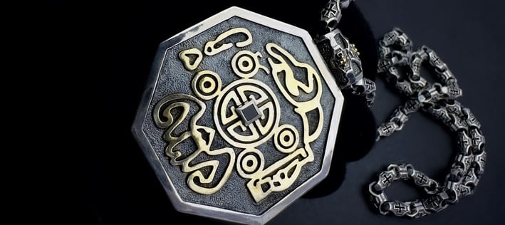 a silver and gold necklace with a MONEY sign
