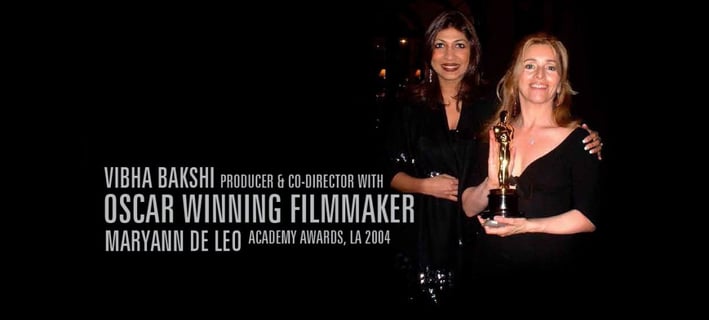Vibha Bakshi & Maryann DeLeo holding a trophy for the oscar award
