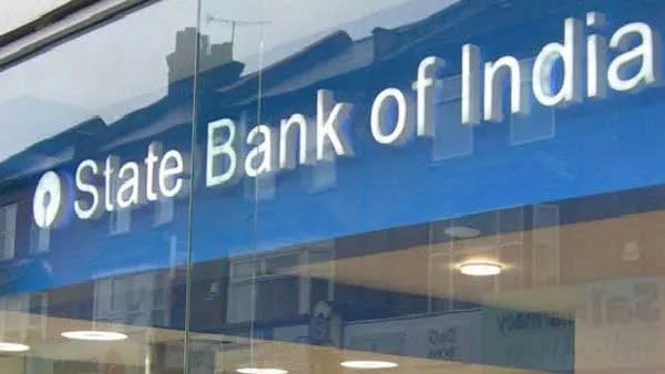 a man in a suit and tie is standing in front of a bank of india