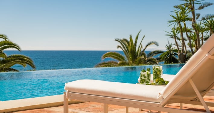Pool area at Villa El Rincon in Marbella with ocean views, designer furnishings, and open-concept Mediterranean design