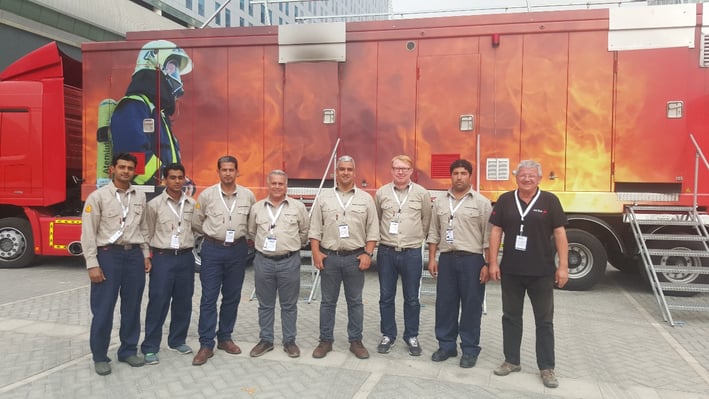 Premiers For Equipment Managers & Staff Standing in Front of MTU (Mobile Training Unit)