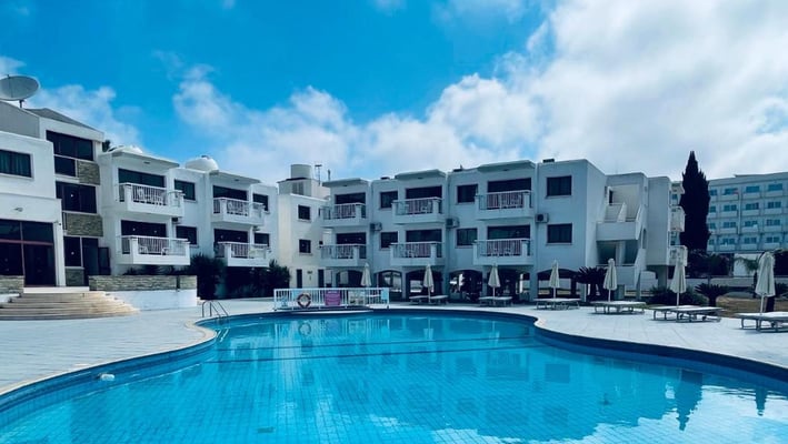 a swimming pool and lounge chairs in Cyprus