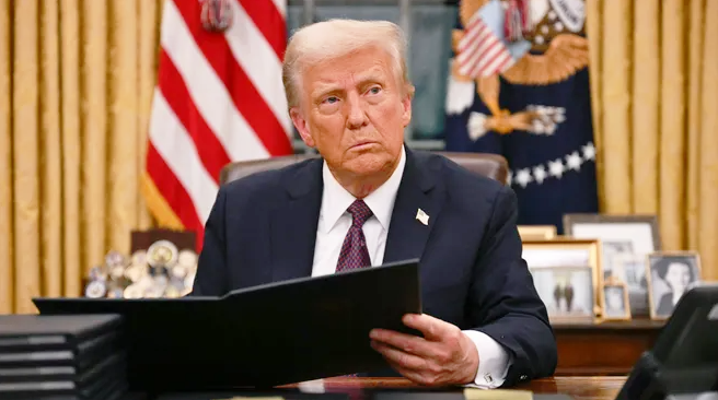 a man in a suit and tie is sitting at a desk