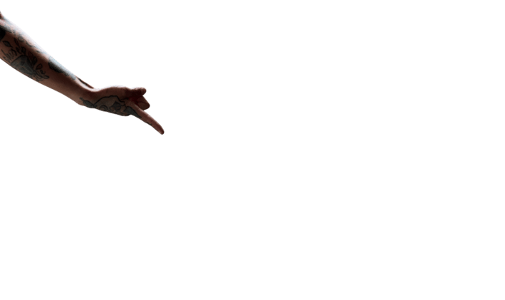tattooed arm pointing downward towards button
