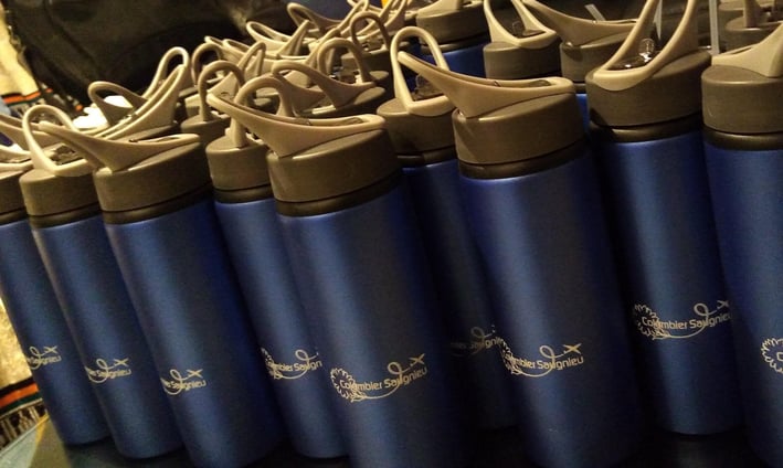 a bunch of blue water bottles with a black and white background